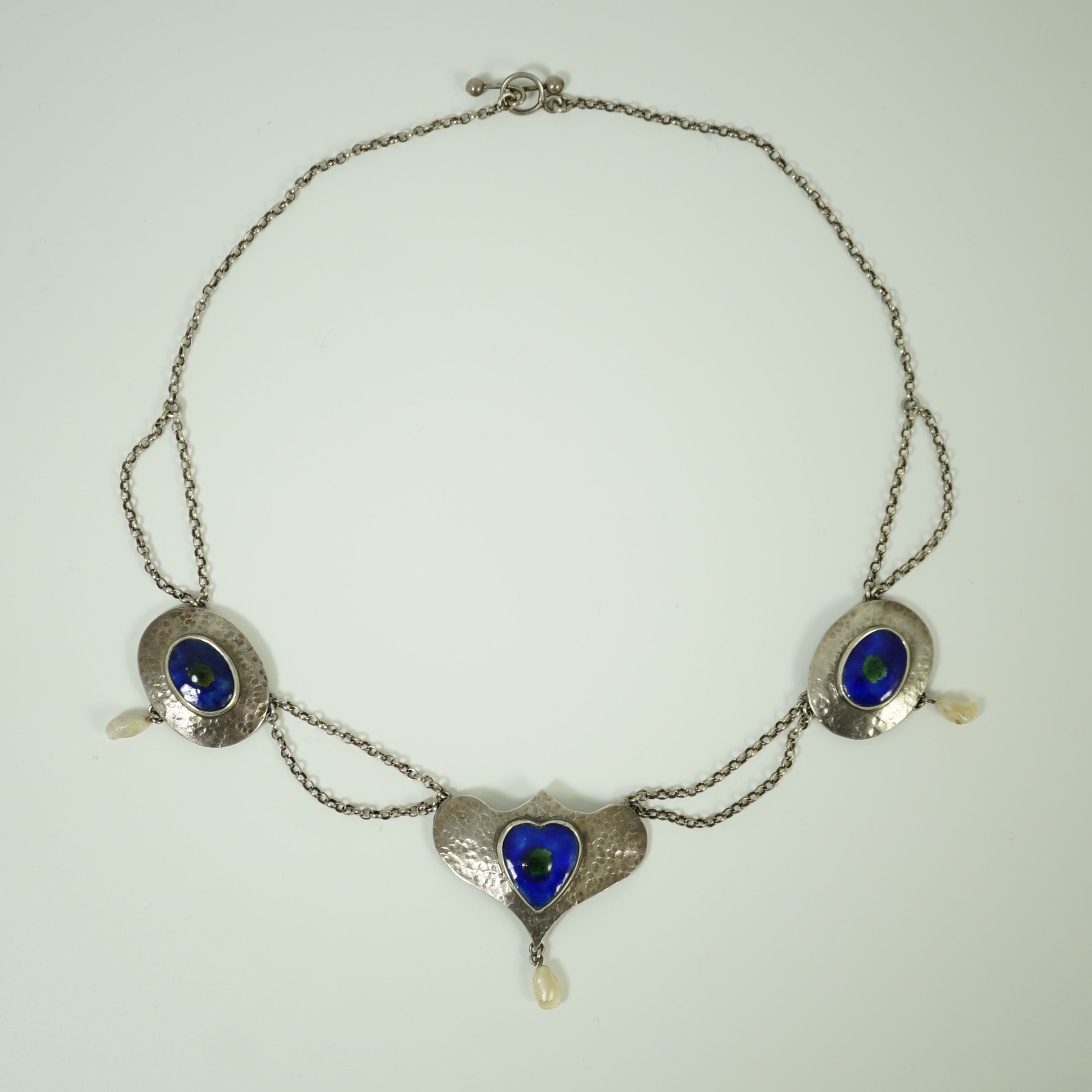 A stylish early 20th century sterling, enamel and baroque drop pearl set necklace